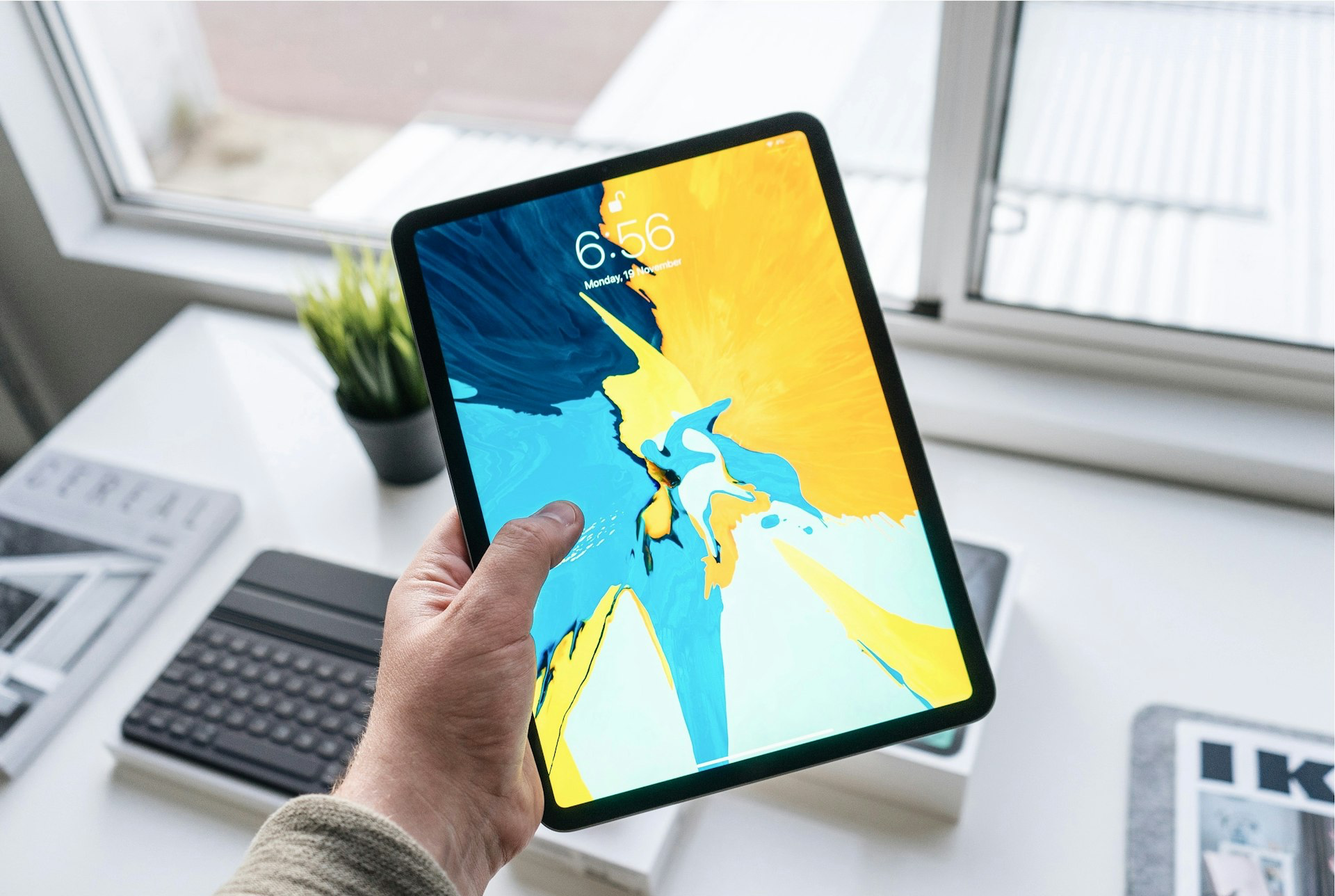 person holding turned-on black iPad