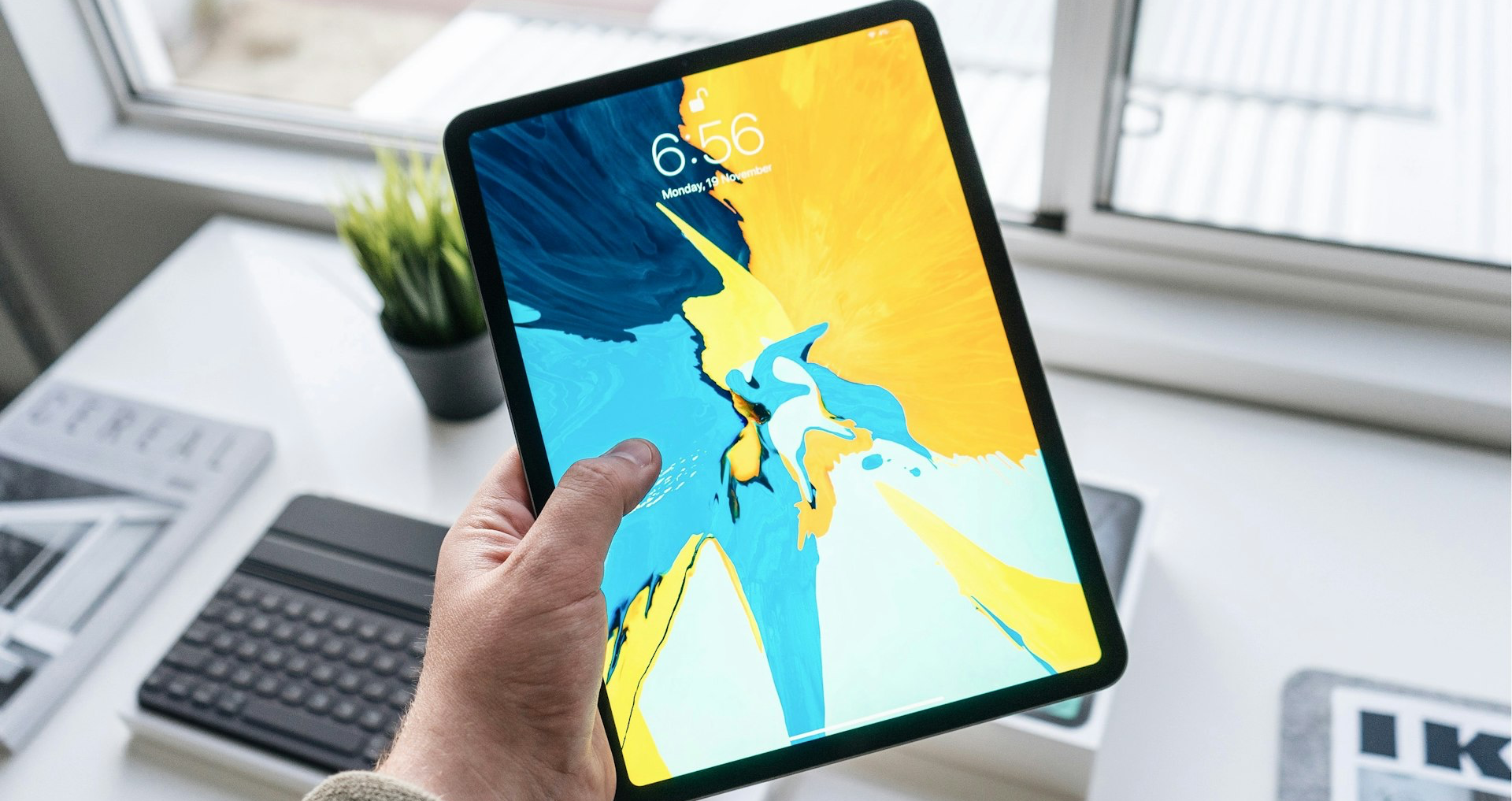 person holding turned-on black iPad