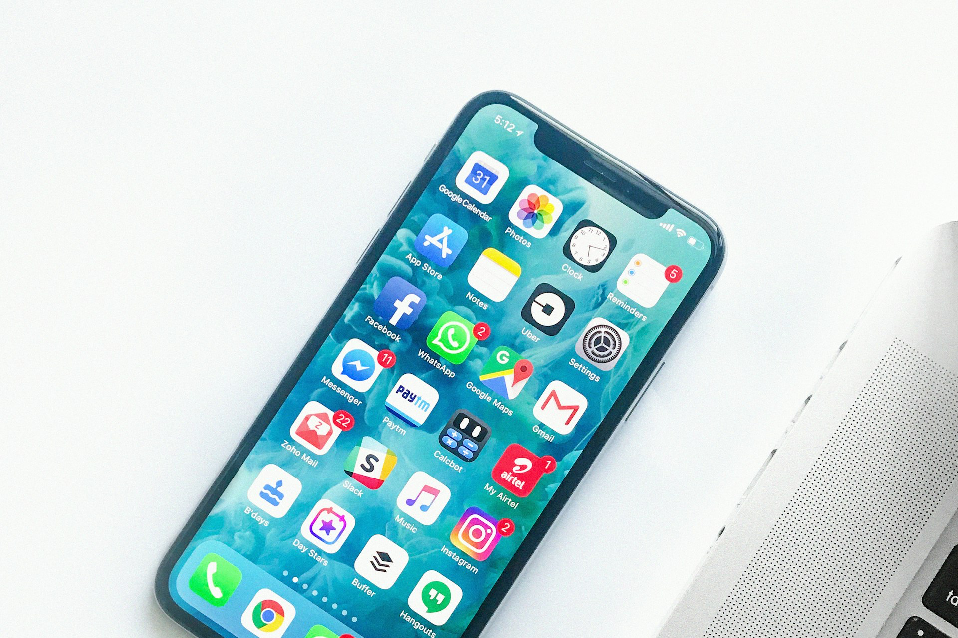 white smartphone near laptop