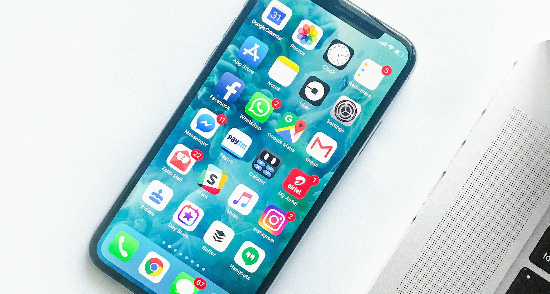white smartphone near laptop